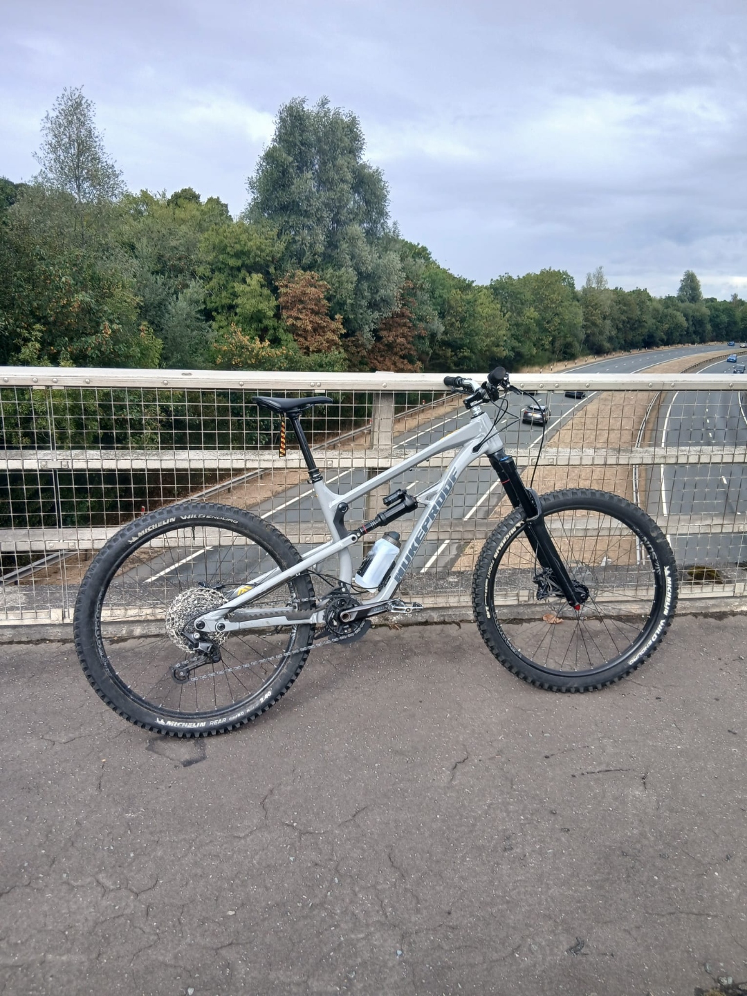 Alfie's silver mountain bike photographed on a bridge.